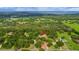 Wide aerial shot of home nestled among lush greenery; a peaceful retreat away from the hustle and bustle at 39132 Grays Airport Rd, Lady Lake, FL 32159