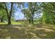A charming backyard featuring large trees and a utility shed providing ample space for outdoor activities and storage at 39132 Grays Airport Rd, Lady Lake, FL 32159