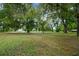 Expansive backyard with mature trees and lush, green grass at 39132 Grays Airport Rd, Lady Lake, FL 32159