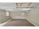 Spacious unfinished basement with white walls and ceiling, offering potential for customization, complemented by a carpeted area at 39132 Grays Airport Rd, Lady Lake, FL 32159
