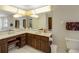 Bathroom features a vanity area with dual sinks and great lighting, along with a toilet and shower at 39132 Grays Airport Rd, Lady Lake, FL 32159