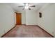 Bedroom features neutral paint, ceiling fan and trim at 39132 Grays Airport Rd, Lady Lake, FL 32159