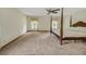 Large bedroom with a four-poster bed, windows with decorative curtains, and a ceiling fan at 39132 Grays Airport Rd, Lady Lake, FL 32159
