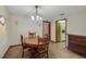 Formal dining area featuring a round wood table and chandelier lighting at 39132 Grays Airport Rd, Lady Lake, FL 32159