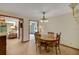 Dining room with wood table, chandelier, and tile floors at 39132 Grays Airport Rd, Lady Lake, FL 32159