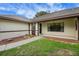 Welcoming front entrance featuring detailed trim, landscaping, and a well-maintained pathway to the door at 39132 Grays Airport Rd, Lady Lake, FL 32159