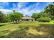 Inviting home with a well-manicured front lawn, surrounded by mature trees, offering curb appeal and a serene setting at 39132 Grays Airport Rd, Lady Lake, FL 32159