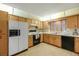 Bright kitchen features wood cabinets, tile floor and modern appliances at 39132 Grays Airport Rd, Lady Lake, FL 32159