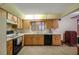 Well-equipped kitchen with wood cabinets, tile backsplash, and modern appliances at 39132 Grays Airport Rd, Lady Lake, FL 32159