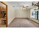 Spacious living room with a large window, plush carpet, and neutral walls, ideal for relaxing and entertaining at 39132 Grays Airport Rd, Lady Lake, FL 32159