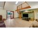 Unique living room with a spiral staircase, high ceilings, skylight, and an open layout perfect for modern living at 39132 Grays Airport Rd, Lady Lake, FL 32159