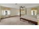 Spacious main bedroom with natural light, carpet floors, and a ceiling fan at 39132 Grays Airport Rd, Lady Lake, FL 32159