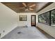 Enclosed sunroom with a ceiling fan, a window, and a door leading to the outdoors at 39132 Grays Airport Rd, Lady Lake, FL 32159