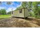 Exterior view of a portable shed with windows, offering additional storage or workspace in a backyard setting at 39132 Grays Airport Rd, Lady Lake, FL 32159
