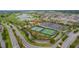 Enjoy aerial views of this neighborhood featuring tennis courts, a golf course, and nearby roadways at 3978 Nottingham Loop, The Villages, FL 32163