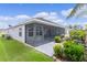 Relax in the screened-in back porch with views of the backyard and a decorative gray concrete patio at 3978 Nottingham Loop, The Villages, FL 32163
