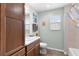 Bright bathroom boasts wood cabinets, shower, tub, and tile flooring at 3978 Nottingham Loop, The Villages, FL 32163