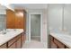 The bathroom features double sinks with wooden cabinets and leads to a separate toilet room for added privacy at 3978 Nottingham Loop, The Villages, FL 32163