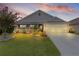 Charming home with a well-manicured lawn, beautiful landscaping, and a two-car garage at 3978 Nottingham Loop, The Villages, FL 32163