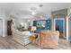 Open-concept living room with hardwood floors, ceiling fan, lots of seating and plenty of space to relax at 3978 Nottingham Loop, The Villages, FL 32163