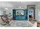 Spacious living room with hardwood floors, ceiling fan, lots of seating and a view of another room at 3978 Nottingham Loop, The Villages, FL 32163