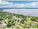 Breathtaking aerial view of the neighborhood featuring mature trees and a large lake at 400 W Washington St, Minneola, FL 34715