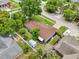 Aerial view of house with large brown roof, manicured lawn, small storage unit and partial privacy fence in the back yard at 400 W Washington St, Minneola, FL 34715