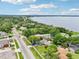 Aerial view shows lakefront neighborhood, tree-lined streets, nearby church, and attractive landscaping of the home at 400 W Washington St, Minneola, FL 34715