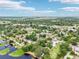 Expansive aerial view of a residential area near the water featuring lush greenery and charming homes at 400 W Washington St, Minneola, FL 34715