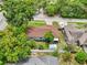 Aerial view of the home with a lush lawn and an outbuilding in the fenced in backyard at 400 W Washington St, Minneola, FL 34715