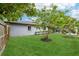 Expansive green backyard featuring a manicured lawn and beautiful landscaping at 400 W Washington St, Minneola, FL 34715