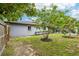 The spacious backyard features a well-maintained lawn and mature trees at 400 W Washington St, Minneola, FL 34715