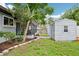 Landscaped backyard featuring a screened-in porch and a storage shed at 400 W Washington St, Minneola, FL 34715