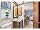 Bathroom featuring a sink vanity, white toilet, wood-look floors and a window at 400 W Washington St, Minneola, FL 34715