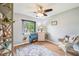 Bedroom features wood-look flooring, a ceiling fan, a window and neutral wall color at 400 W Washington St, Minneola, FL 34715
