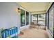 Enclosed porch features tile flooring, a table and chairs, and nice outdoor views at 400 W Washington St, Minneola, FL 34715