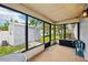 The enclosed back porch features a side yard view with a shed and an outdoor table at 400 W Washington St, Minneola, FL 34715