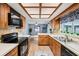 Kitchen with wood cabinets, modern appliances, and eat in counter at 400 W Washington St, Minneola, FL 34715