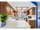 The well-lit kitchen with white countertops, stainless steel appliances, and ample cabinet space at 400 W Washington St, Minneola, FL 34715