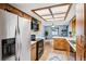 Open kitchen features stainless steel refrigerator and plenty of cabinet space at 400 W Washington St, Minneola, FL 34715