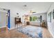 Bright and airy living room with laminate floors, ceiling fan and large window at 400 W Washington St, Minneola, FL 34715