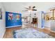 Open-concept living area featuring hardwood floors, ceiling fan and bright wall accents at 400 W Washington St, Minneola, FL 34715