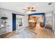 View of the living room with wood-look flooring, ceiling fan, and an open view to the kitchen at 400 W Washington St, Minneola, FL 34715