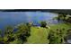 Expansive lakefront property featuring a large manicured lawn, private dock, and scenic views at 4634 Bigler Ln, Mount Dora, FL 32757