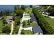 Aerial view of lakefront homes, lush landscaping, docks, and boat lifts at 4634 Bigler Ln, Mount Dora, FL 32757