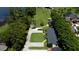 Lakeside property showcasing a long driveway, lush trees, and beautiful waterfront views, ideal for serene living at 4634 Bigler Ln, Mount Dora, FL 32757