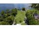 Large lakefront lot featuring expansive green space, mature trees, and stunning water views perfect for relaxation at 4634 Bigler Ln, Mount Dora, FL 32757
