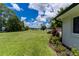 Spacious backyard with lush green lawn and mature trees, perfect for outdoor entertaining at 4634 Bigler Ln, Mount Dora, FL 32757