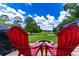 Expansive backyard featuring a fire pit, lush lawn, and lake views in the distance at 4634 Bigler Ln, Mount Dora, FL 32757
