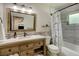 Well-lit bathroom with a wood vanity, updated countertops, and tiled shower/tub combo at 4634 Bigler Ln, Mount Dora, FL 32757